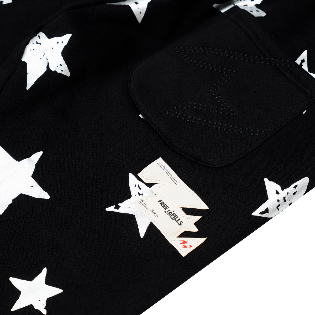 Black fabric product with a white star print pattern and a black pocket, photographed on a white background.