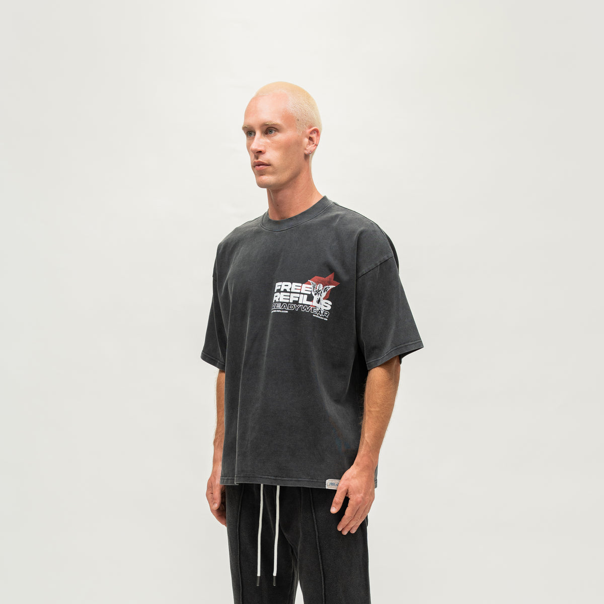 Sunday Service Tee – Black – Angled view on model showing chest graphic and short sleeves