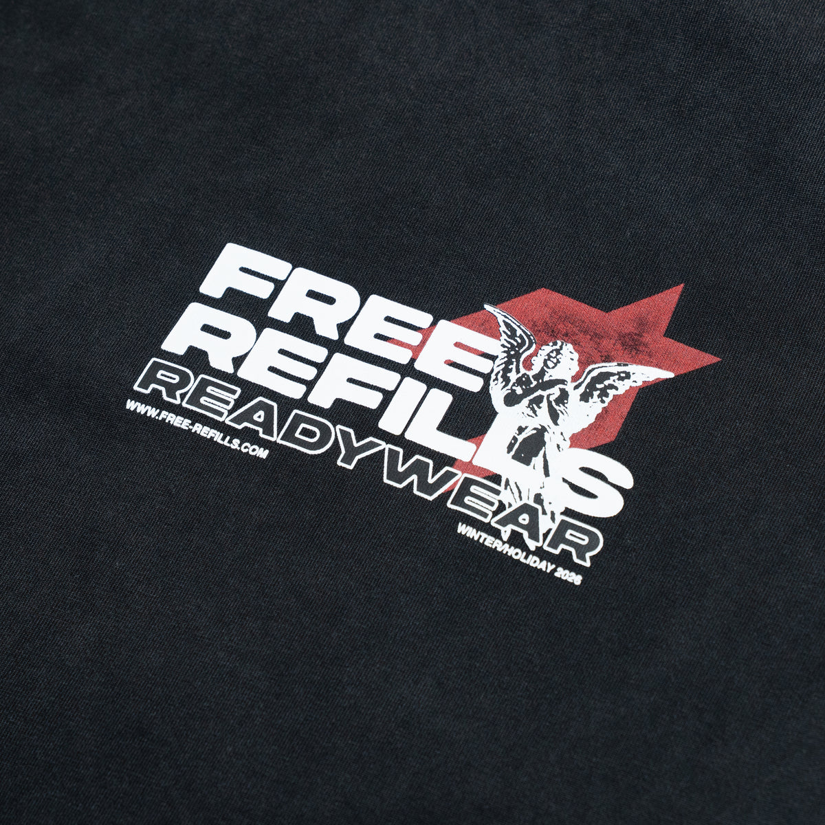 Sunday Service Tee – Black – Close-up of FREE ReFILLS chest lettering and cherub over red graphic