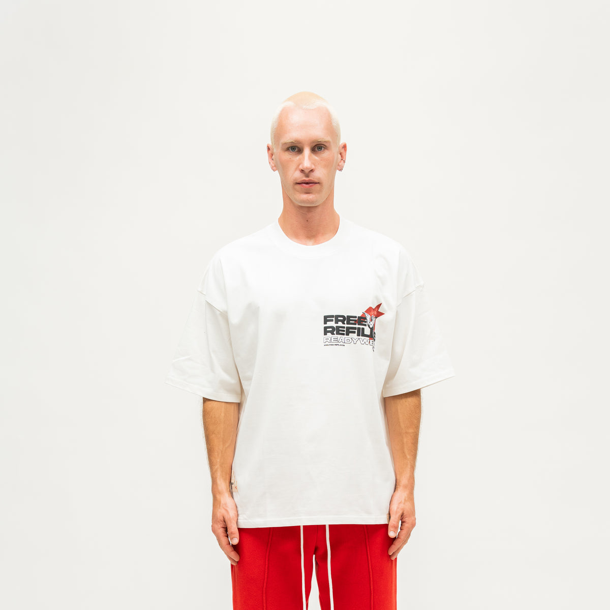 Sunday Service Tee – Cream – Front view on model showing small FREE ReFILLS chest graphic
