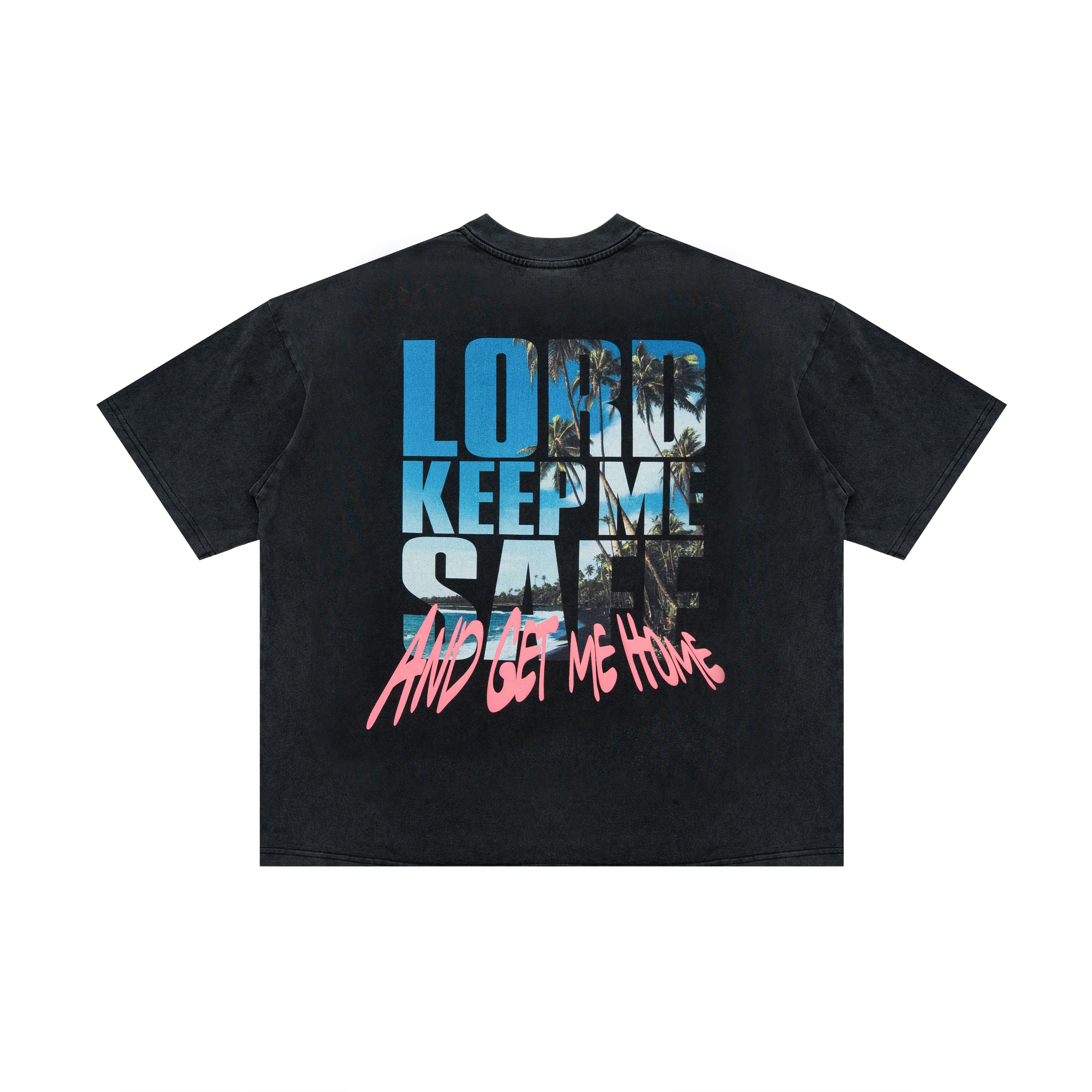 A black washed short-sleeve t-shirt with a large graphic print on the back. The graphic features the text 'LORD KEEP ME SAFE' in blue and white block letters with a palm tree pattern, and 'AND GET ME HOME' in pink graffiti-style lettering below it.