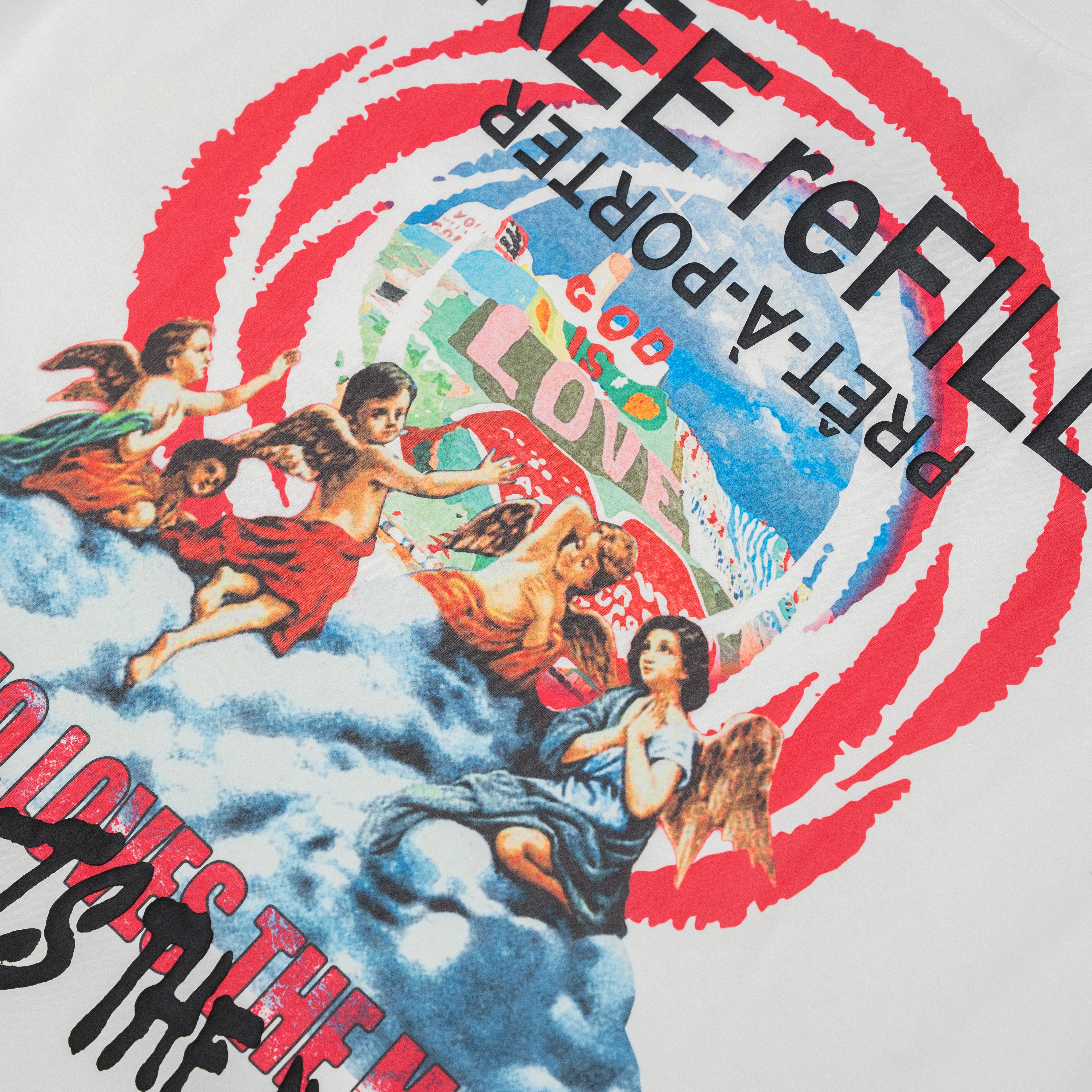 Close-up of a white graphic T-shirt featuring a colorful vintage-style illustration with cherubs, red circular brushstroke elements, and black text including 'PRET-À-PORTER' and 'FREE reFILL'.