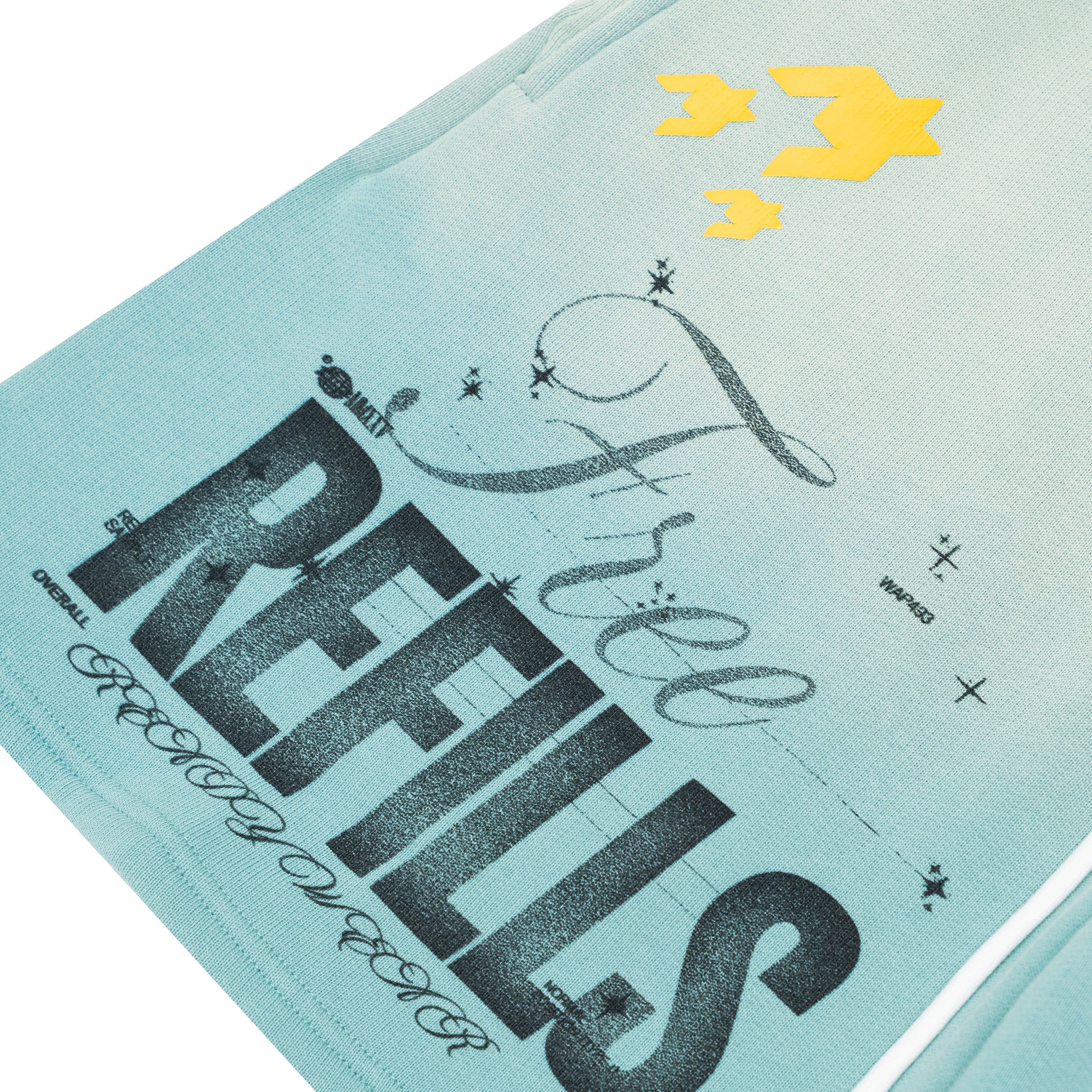 A close-up of a light blue graphic t-shirt featuring the text 'Free REFILLS' in black, with yellow star graphics near the top right.