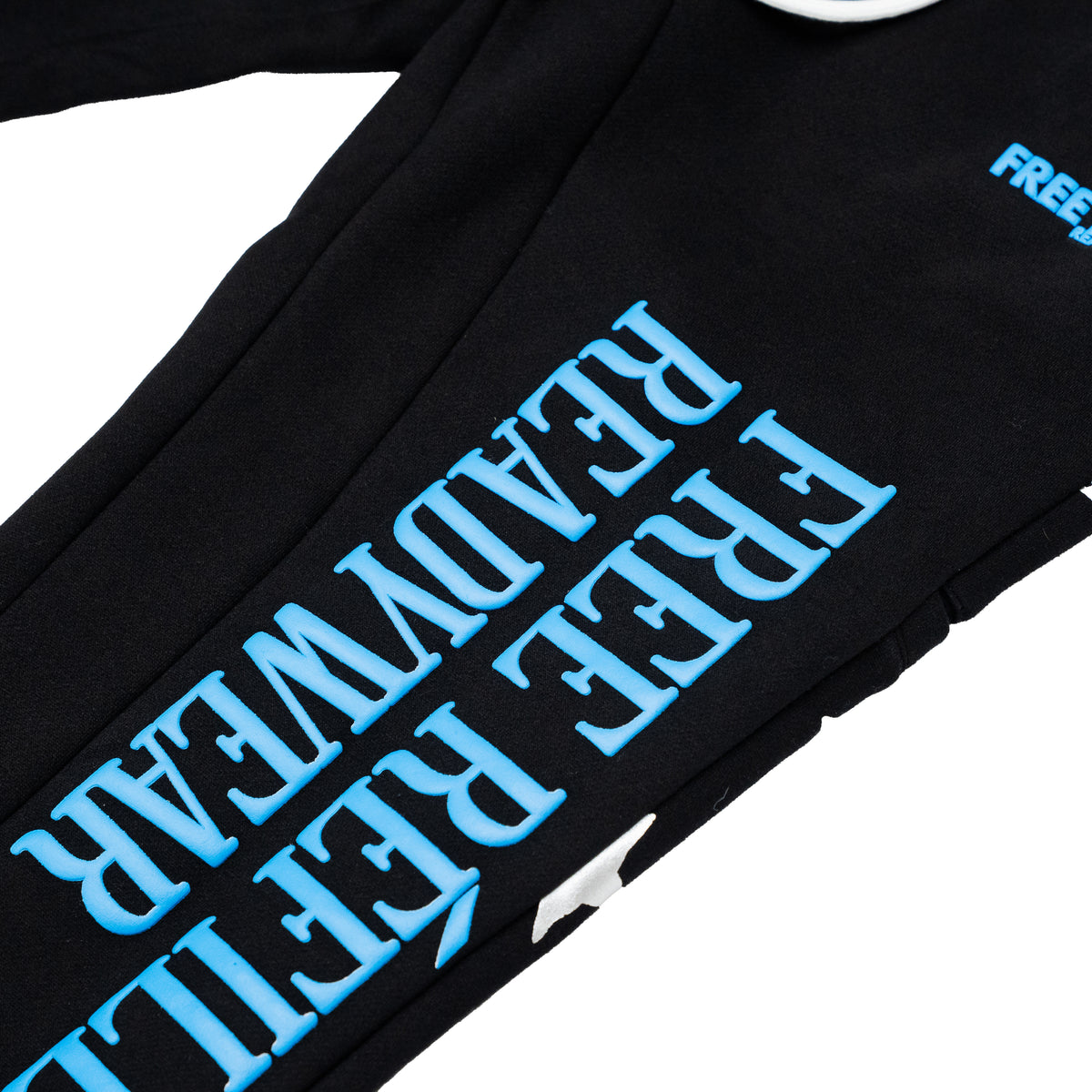 Close-up of a black sweatshirt with large light blue text reading 'FREE REFILLS' and 'READYWEAR' printed diagonally, plus a small light blue 'FREE' logo.