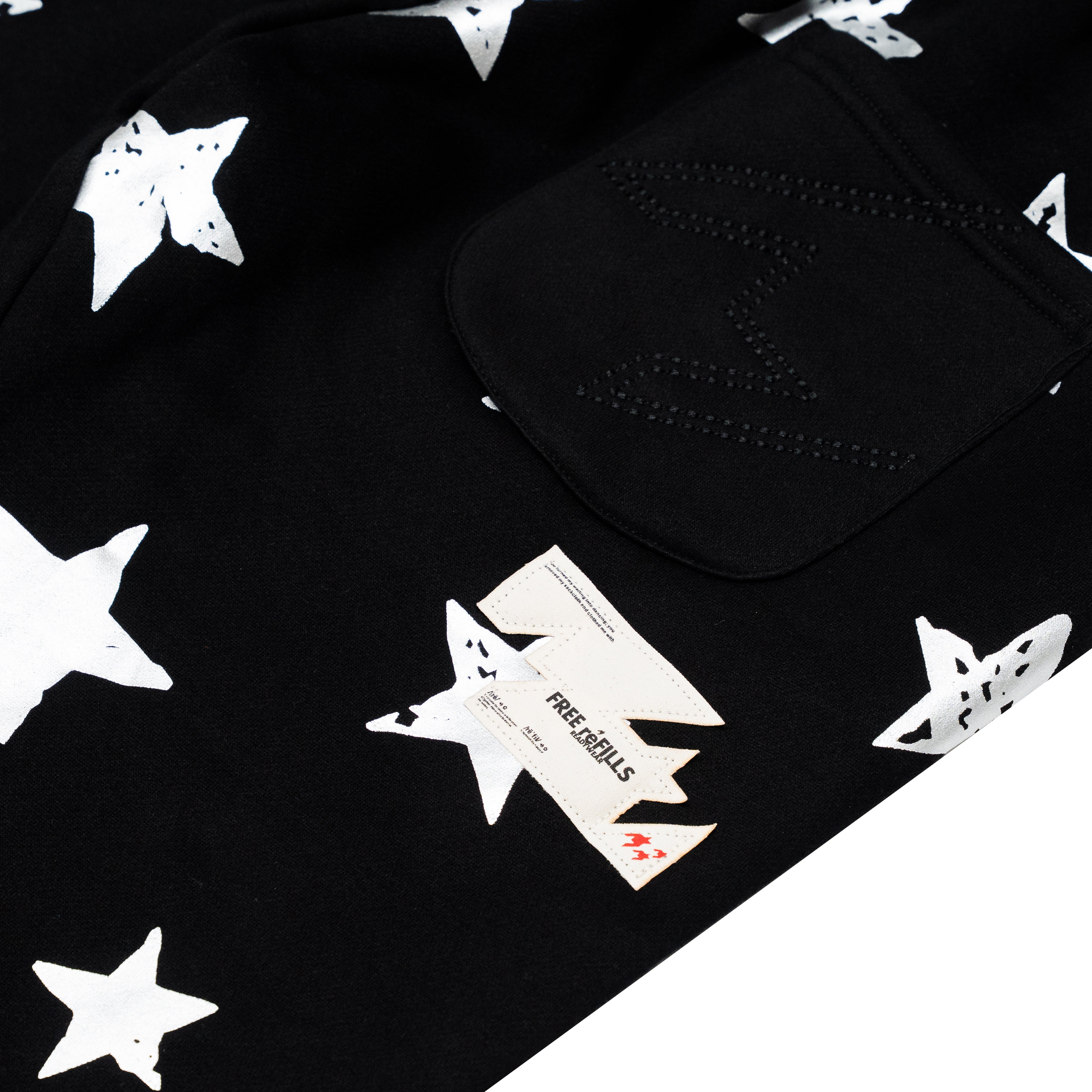 Black fabric product with a white star print pattern and a black pocket, photographed on a white background.