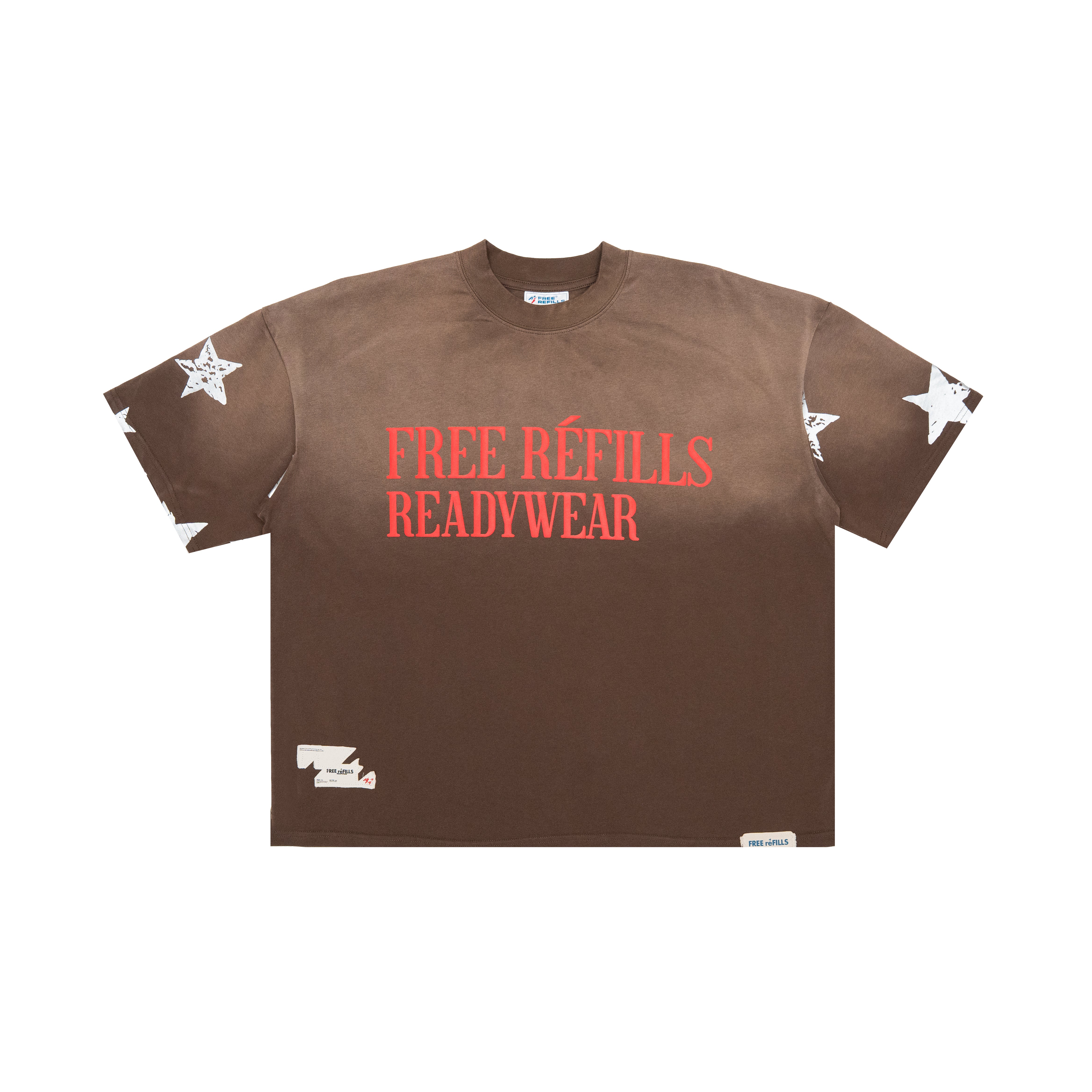 A brown short-sleeve t-shirt with 'FREE REFILLS READYWEAR' printed in red across the chest, featuring distressed details and white star graphics on the sleeves, shown on a plain white background.
