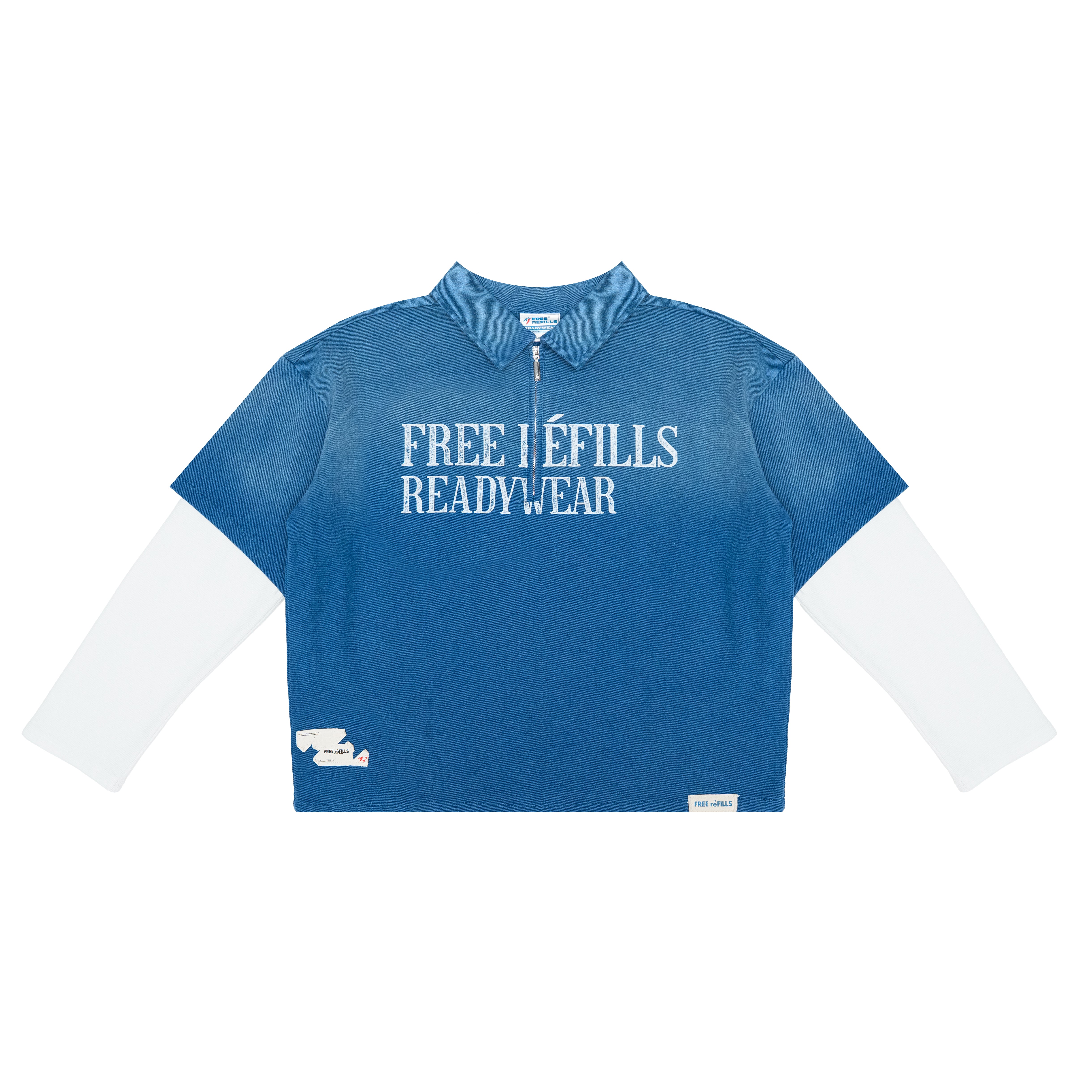 A blue long-sleeve quarter-zip pullover top with white text reading 'FREE REFILLS READYWEAR' across the chest, layered over a white long-sleeve base, shown on a plain white background.
