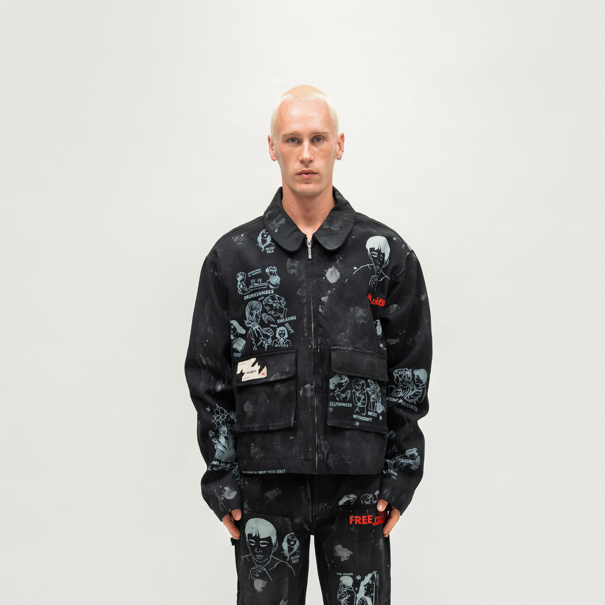 Miracle Jacket – Black – Front view on model showing illustrated graphics, zip closure, and flap pockets.