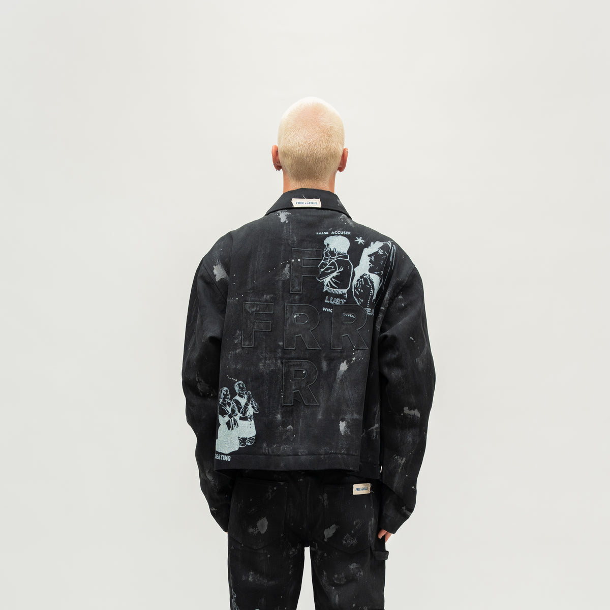Miracle Jacket – Black – Back view on model showing tonal FRR lettering and illustrated graphics.