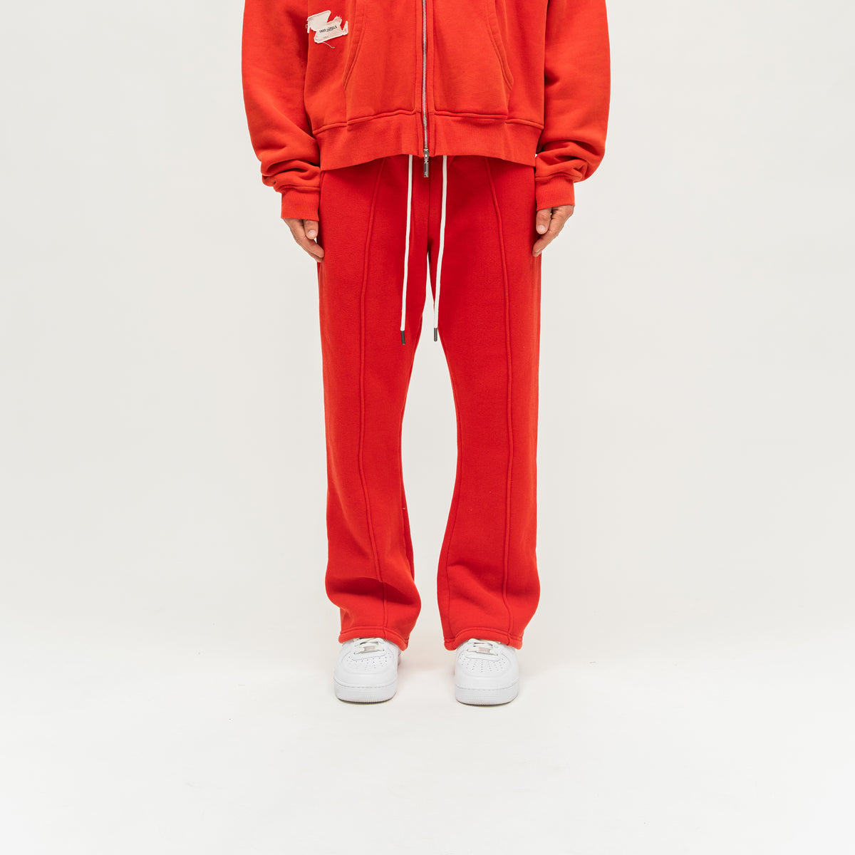 Sunday Service Flare Bottoms – Red – Front view on model showing white drawstring, raised leg seams and flared hems