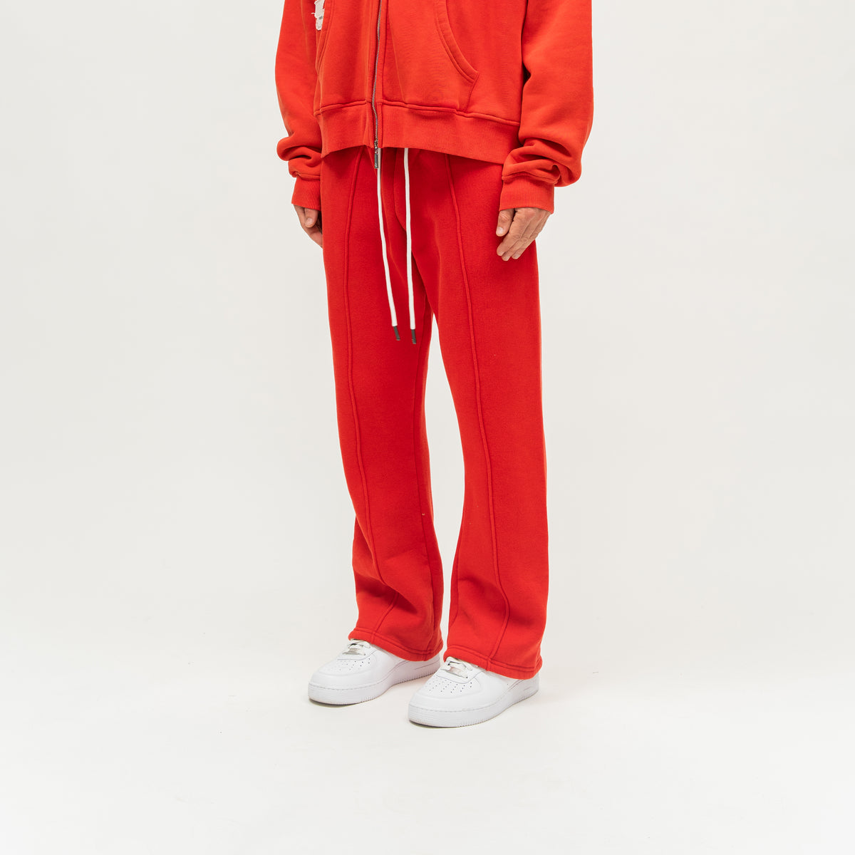 Sunday Service Flare Bottoms – Red – Angled view on model showing raised front seams and flared legs