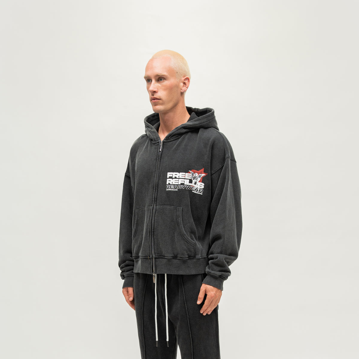 Sunday Service Hoodie – Black – Angled view on model showing hood and chest graphic