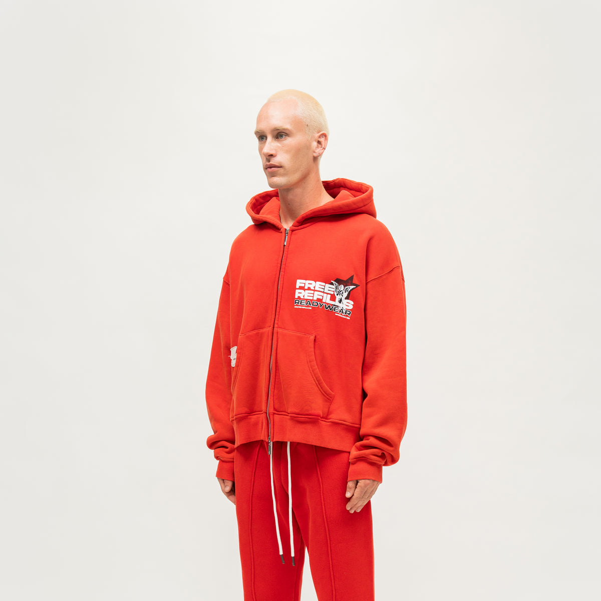 Sunday Service Hoodie – Red – Angled view on model showing hood and chest graphic