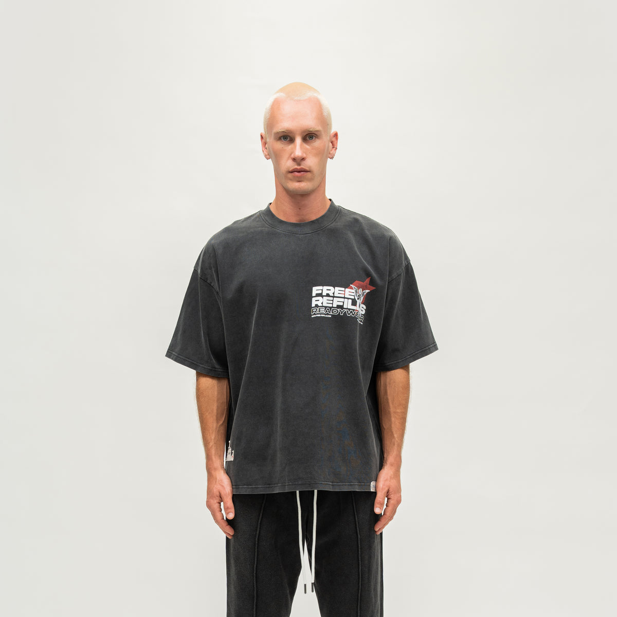 Sunday Service Tee – Black – Front view on model showing small FREE ReFILLS chest graphic