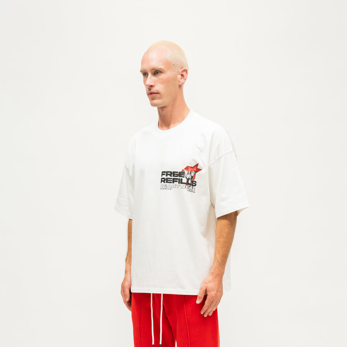 Sunday Service Tee – Cream – Angled view on model showing chest graphic and short sleeves