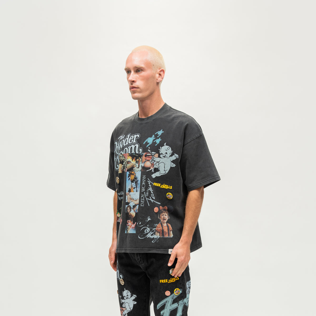 The Powder Room Tee – Black – Angled view on model showing cherub, lettering and collage prints